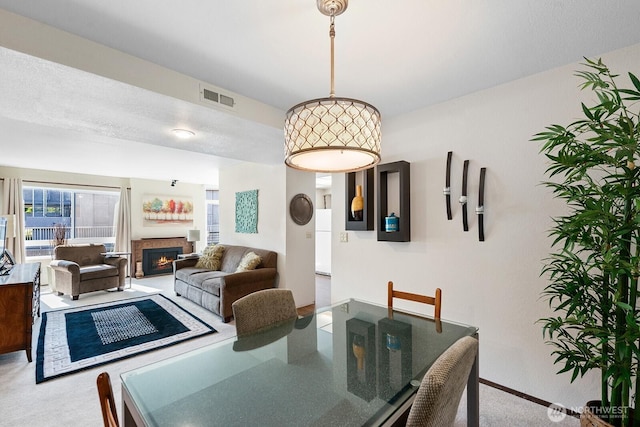 11300 1st Ave NE # 224, Seattle, WA 98125 - carpeted dining area with a lit fireplace and baseboards