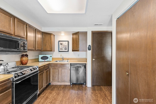 11300 1st Ave NE # 224, Seattle, WA 98125 - kitchen featuring black microwave, dishwasher, range with electric stovetop, white microwave, and a sink