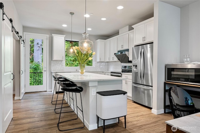 13421 Admiralty Way Unit A-2, Lynnwood, WA 98087 - kitchen with stainless steel appliances, a barn door, tasteful backsplash, recessed lighting, and white cabinetry