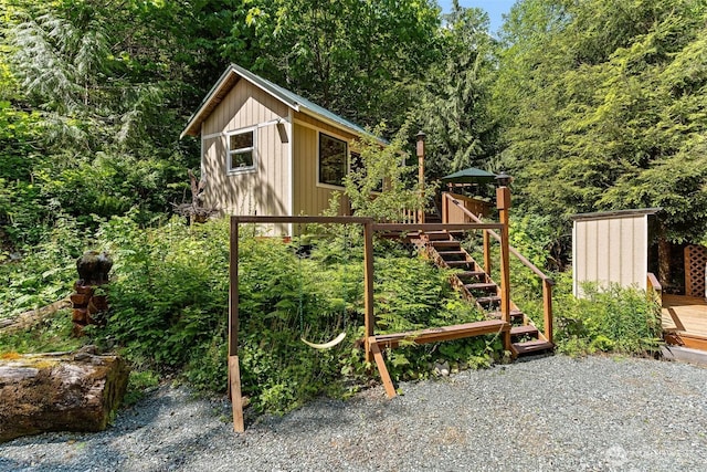 60018 Index Galena Rd, Sultan, WA 98294 - view of play area featuring a deck, an outdoor structure, stairway, and a view of trees
