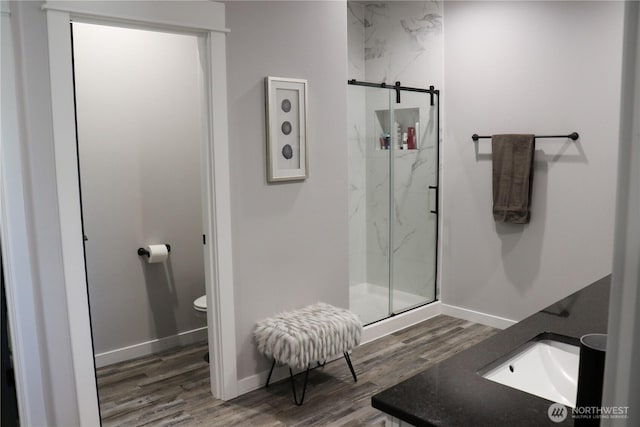 6354 Murray Way NE, Moses Lake, WA 98837 - full bath featuring a marble finish shower, wood finished floors, toilet, and baseboards