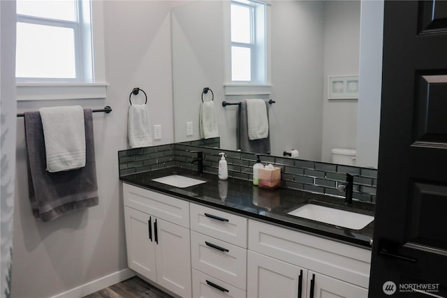 6354 Murray Way NE, Moses Lake, WA 98837 - bathroom featuring plenty of natural light, double vanity, decorative backsplash, and toilet