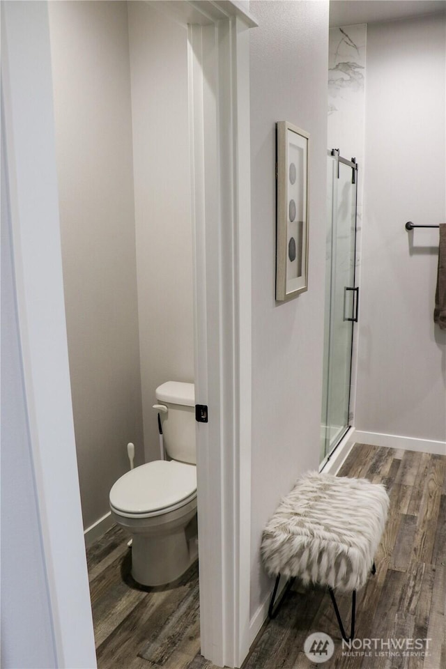 6354 Murray Way NE, Moses Lake, WA 98837 - bathroom featuring wood finished floors, a shower stall, and toilet