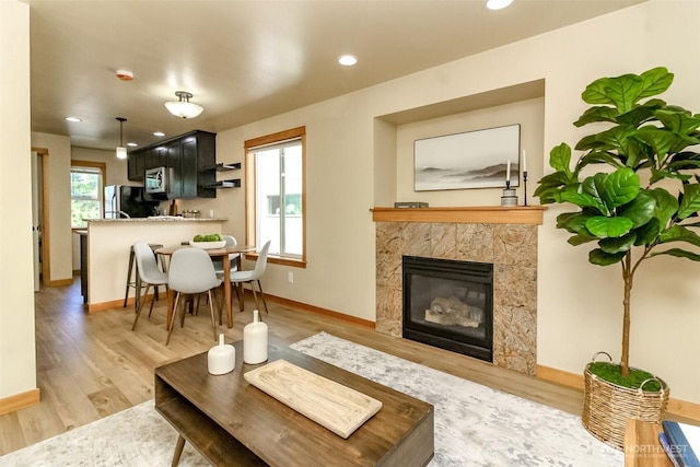 9415 35th Ave SW Unit A, Seattle, WA 98126 - living room featuring light wood-style flooring, a high end fireplace, and recessed lighting