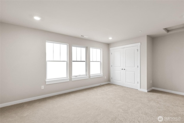 13487 NE 105th Ct Unit 11, Kirkland, WA 98033 - unfurnished bedroom featuring light colored carpet, baseboards, recessed lighting, and a closet