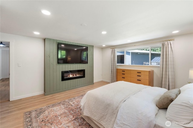 1902 Tellkamp Rd NE, Olympia, WA 98506 - bedroom with light wood-type flooring, a large fireplace, baseboards, and recessed lighting