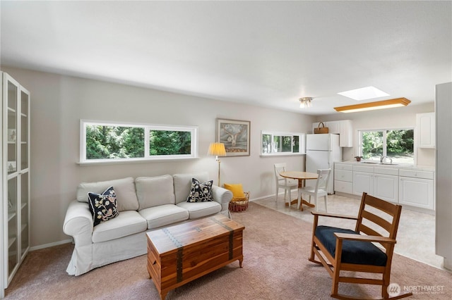 1902 Tellkamp Rd NE, Olympia, WA 98506 - living room with a skylight, light carpet, and baseboards