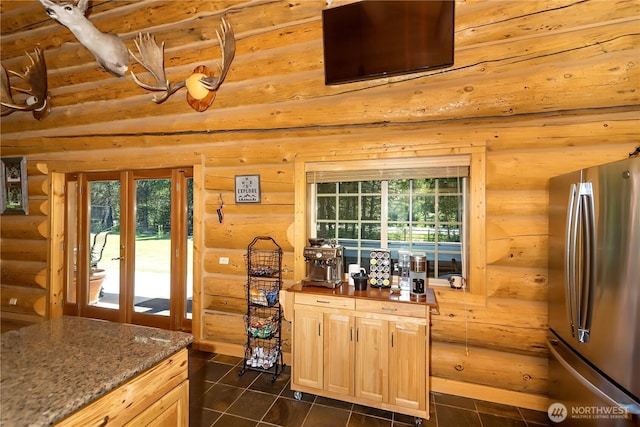 18680 US Highway 2, Lake Wenatchee, WA 98826 - kitchen with freestanding refrigerator, log walls, plenty of natural light, light brown cabinets, and dark tile patterned flooring
