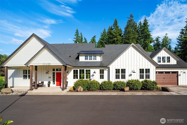 19428 NE 259th St S, Battle Ground, WA 98604 - modern inspired farmhouse featuring board and batten siding, a garage, a porch, concrete driveway, and a shingled roof