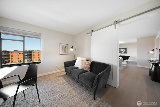 2330 43rd Ave E Unit 403B, Seattle, WA 98112 - living area with baseboards, a barn door, and wood finished floors