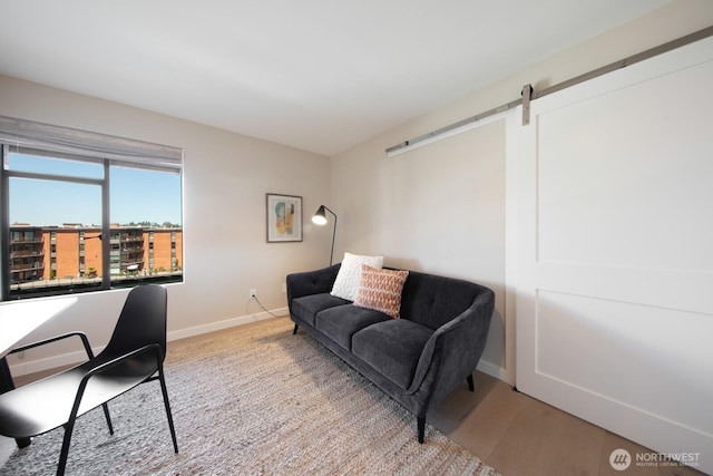 2330 43rd Ave E Unit 403B, Seattle, WA 98112 - office with a barn door, baseboards, and light wood-style flooring