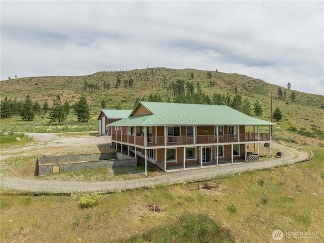 29 Barn Dance Dr, Pateros, WA 98846 - rear view of house featuring an outdoor structure, a mountain view, driveway, and a metal roof