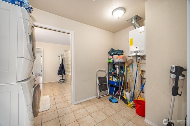 29 Barn Dance Dr, Pateros, WA 98846 - laundry room with stacked washing machine and dryer, tankless water heater, and light tile patterned floors