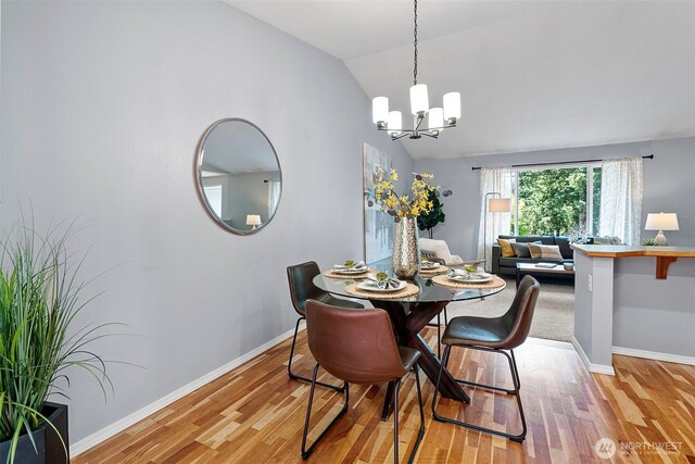 9009 NW 146th St, Gig Harbor, WA 98329 - dining room with a chandelier, light wood finished floors, vaulted ceiling, and baseboards