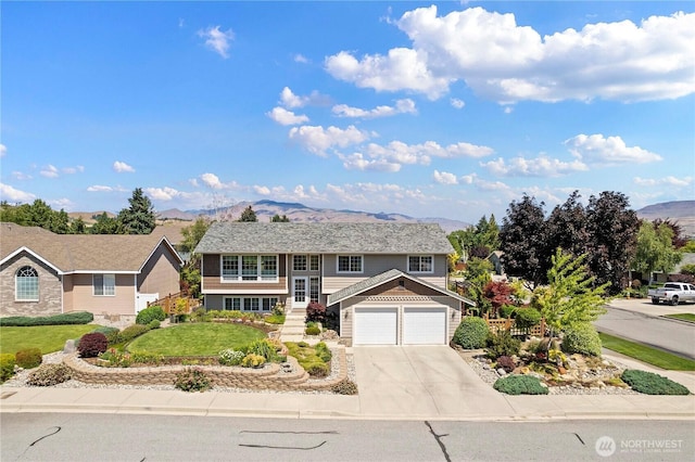 1600 Brandi Ct, Wenatchee, WA 98801 - bi-level home with a mountain view, driveway, a garage, a front lawn, and french doors