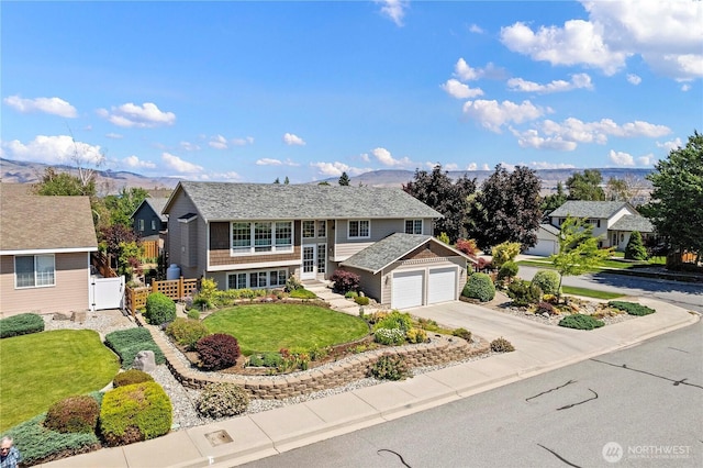 1600 Brandi Ct, Wenatchee, WA 98801 - view of front of home with an attached garage, concrete driveway, french doors, a mountain view, and a residential view