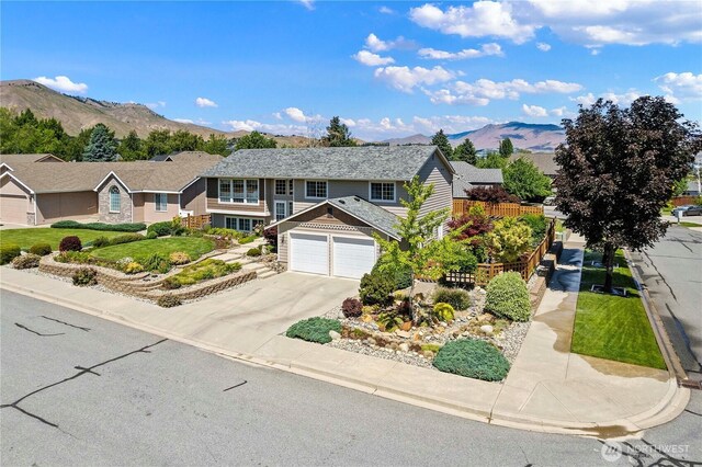 1600 Brandi Ct, Wenatchee, WA 98801 - view of front of house featuring a mountain view, driveway, a garage, and a residential view