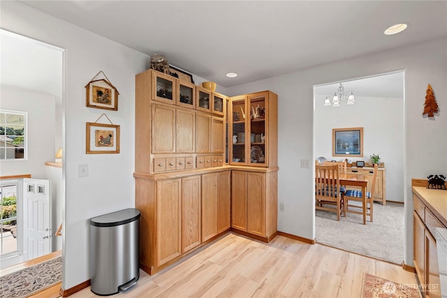 1600 Brandi Ct, Wenatchee, WA 98801 - kitchen with light wood-style floors, a chandelier, light countertops, glass insert cabinets, and recessed lighting