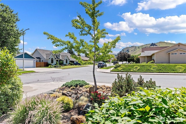 1600 Brandi Ct, Wenatchee, WA 98801 - view of asphalt street with street lights, curbs, a residential view, a mountain view, and sidewalks