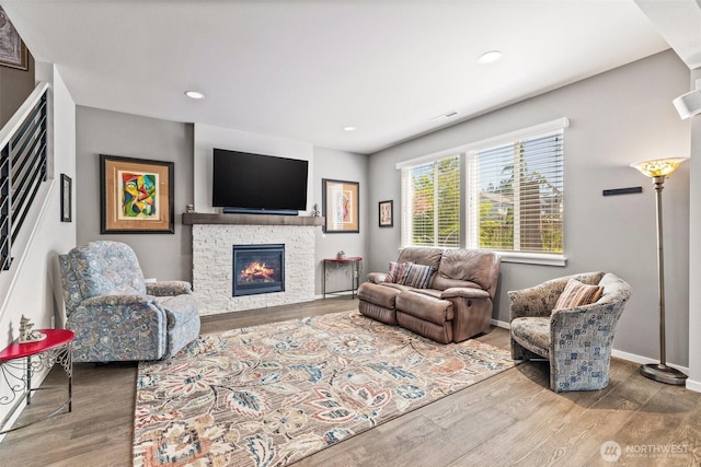 2207 115th Dr SE, Lake Stevens, WA 98258 - living area featuring wood finished floors, a stone fireplace, and recessed lighting