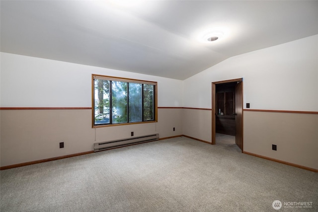 16757 Chilberg Ave, La Conner, WA 98257 - spare room featuring a baseboard radiator, light carpet, vaulted ceiling, and baseboards