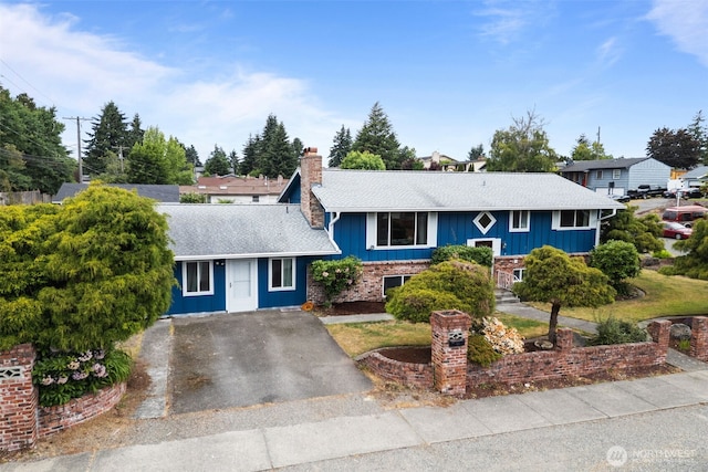 1350 S Woodlawn St, Tacoma, WA 98465 - view of front of home featuring a chimney, a shingled roof, board and batten siding, and driveway