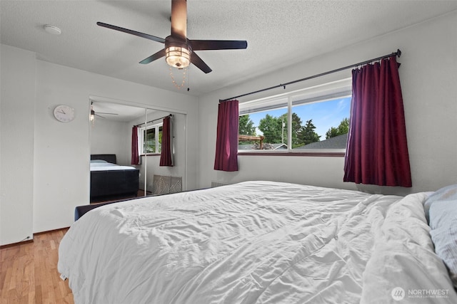 1350 S Woodlawn St, Tacoma, WA 98465 - bedroom featuring wood finished floors, a closet, ceiling fan, and a textured ceiling