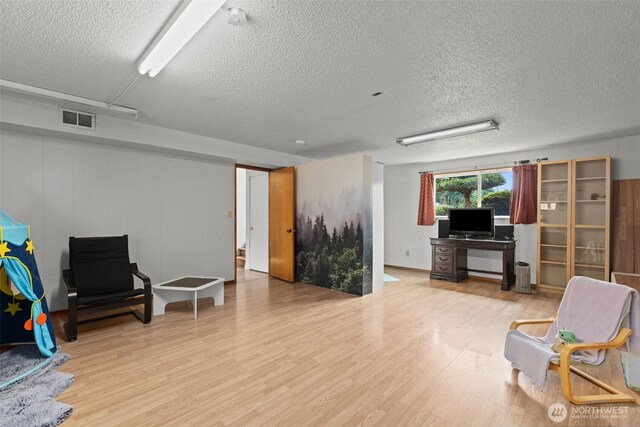 1350 S Woodlawn St, Tacoma, WA 98465 - sitting room featuring wood finished floors and a textured ceiling