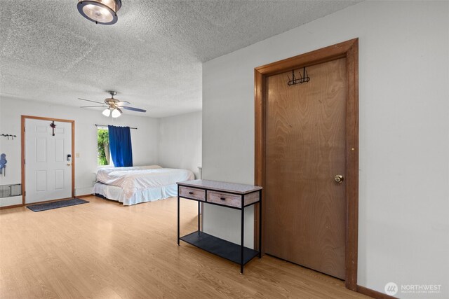 1350 S Woodlawn St, Tacoma, WA 98465 - bedroom featuring a textured ceiling, wood finished floors, and ceiling fan