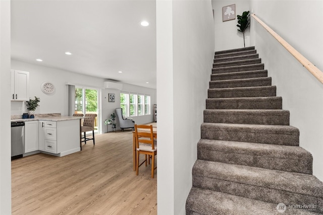 117 Sundown Ct, Chehalis, WA 98532 - stairs featuring wood finished floors, a wall mounted air conditioner, and recessed lighting