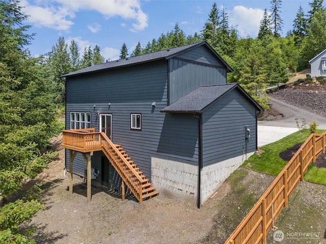 117 Sundown Ct, Chehalis, WA 98532 - back of house featuring stairway, a wooden deck, a fenced backyard, and a shingled roof