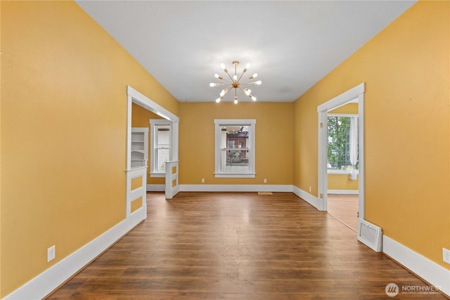 506 Douglas St, Wenatchee, WA 98801 - spare room featuring a chandelier, dark wood-style floors, and baseboards