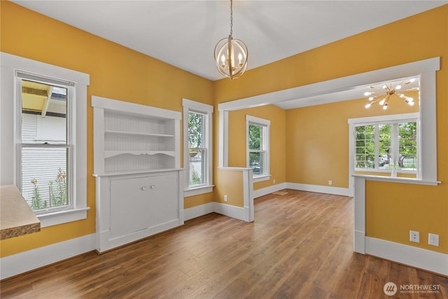 506 Douglas St, Wenatchee, WA 98801 - unfurnished dining area featuring a chandelier, baseboards, and wood finished floors