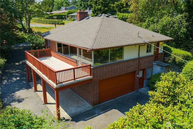 17004 16th Ave SW, Normandy Park, WA 98166 - back of house featuring brick siding, roof with shingles, a garage, and a chimney