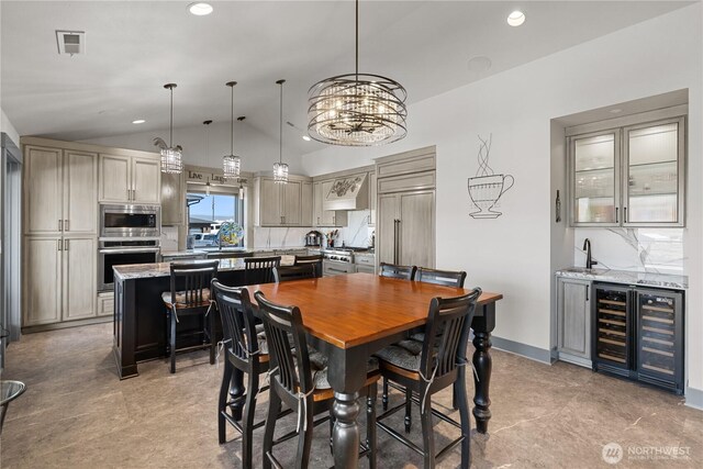 111 Wren Loop SW, Mattawa, WA 99349 - dining room with beverage cooler, lofted ceiling, bar with sink, recessed lighting, and a chandelier