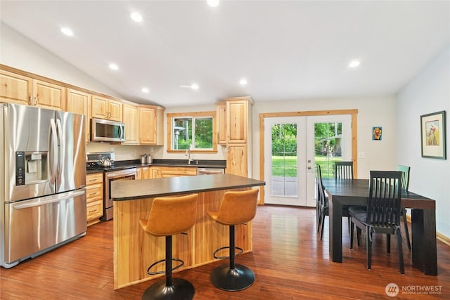 11924 210th St E, Graham, WA 98338 - kitchen with stainless steel appliances, light brown cabinets, a sink, dark countertops, and dark wood finished floors