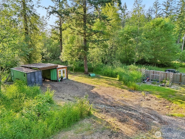 11924 210th St E, Graham, WA 98338 - view of yard featuring a wooded view and an outdoor structure