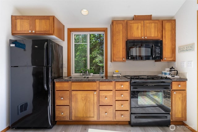11009E Lake Joy Dr NE, Carnation, WA 98014 - kitchen with black appliances, a sink, brown cabinetry, light wood finished floors, and recessed lighting