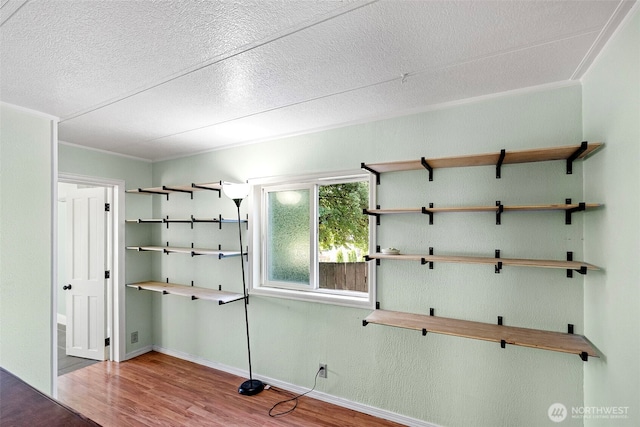4133 W N St, Bremerton, WA 98312 - empty room featuring wood finished floors, a textured ceiling, and baseboards