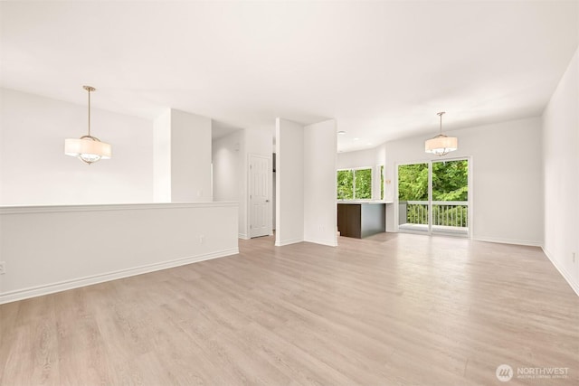 1999 Governor Rd, Bellingham, WA 98229 - unfurnished living room with baseboards and light wood-style flooring