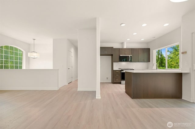 1999 Governor Rd, Bellingham, WA 98229 - kitchen featuring appliances with stainless steel finishes, light wood-style flooring, a peninsula, light countertops, and recessed lighting