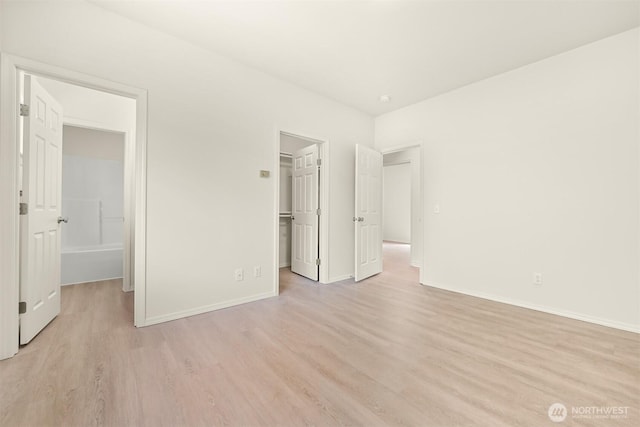 1999 Governor Rd, Bellingham, WA 98229 - unfurnished bedroom featuring light wood-style floors and a walk in closet