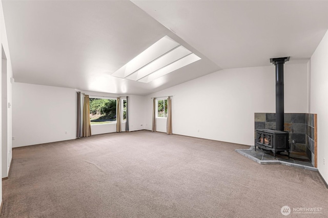 4441 Forgotten Ln, Clinton, WA 98236 - unfurnished living room with a wood stove, carpet, and lofted ceiling