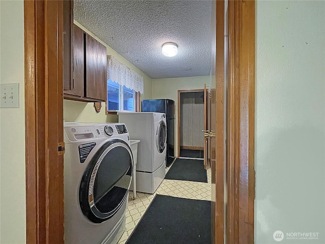 2208 Sandra Ave, Centralia, WA 98531 - laundry area with washing machine and clothes dryer, cabinet space, light floors, and a textured ceiling
