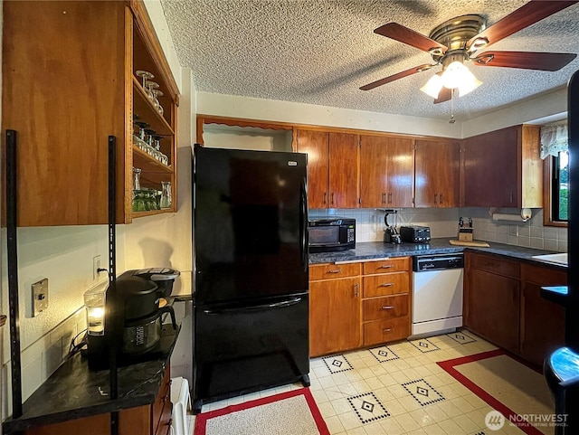 2208 Sandra Ave, Centralia, WA 98531 - kitchen featuring black appliances, ceiling fan, dark countertops, decorative backsplash, and a textured ceiling
