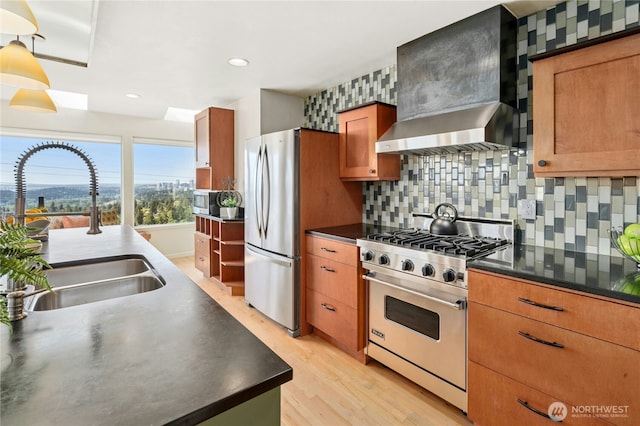 13712 SE 44th St, Bellevue, WA 98006 - kitchen featuring appliances with stainless steel finishes, a sink, wall chimney exhaust hood, light wood finished floors, and dark countertops
