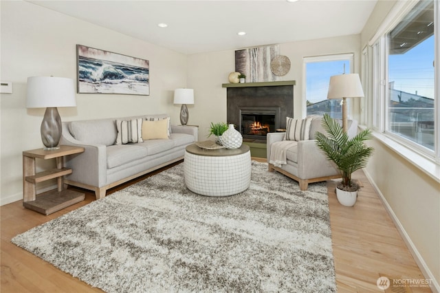 13712 SE 44th St, Bellevue, WA 98006 - living room with a glass covered fireplace, wood finished floors, baseboards, and recessed lighting
