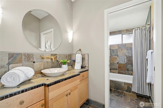13712 SE 44th St, Bellevue, WA 98006 - full bathroom featuring stone tile floors, vanity, tiled shower / bath, and backsplash