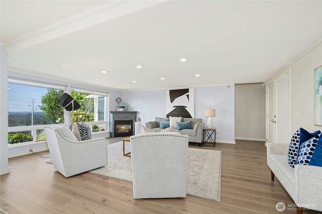 13712 SE 44th St, Bellevue, WA 98006 - living area with crown molding, plenty of natural light, light wood finished floors, a glass covered fireplace, and recessed lighting