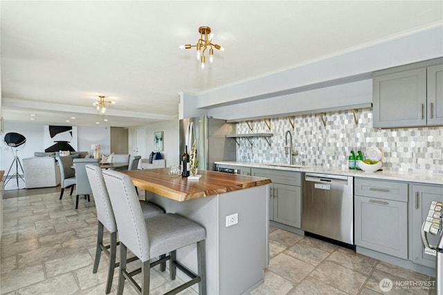 13712 SE 44th St, Bellevue, WA 98006 - kitchen featuring gray cabinetry, stainless steel appliances, a sink, wooden counters, and ornamental molding